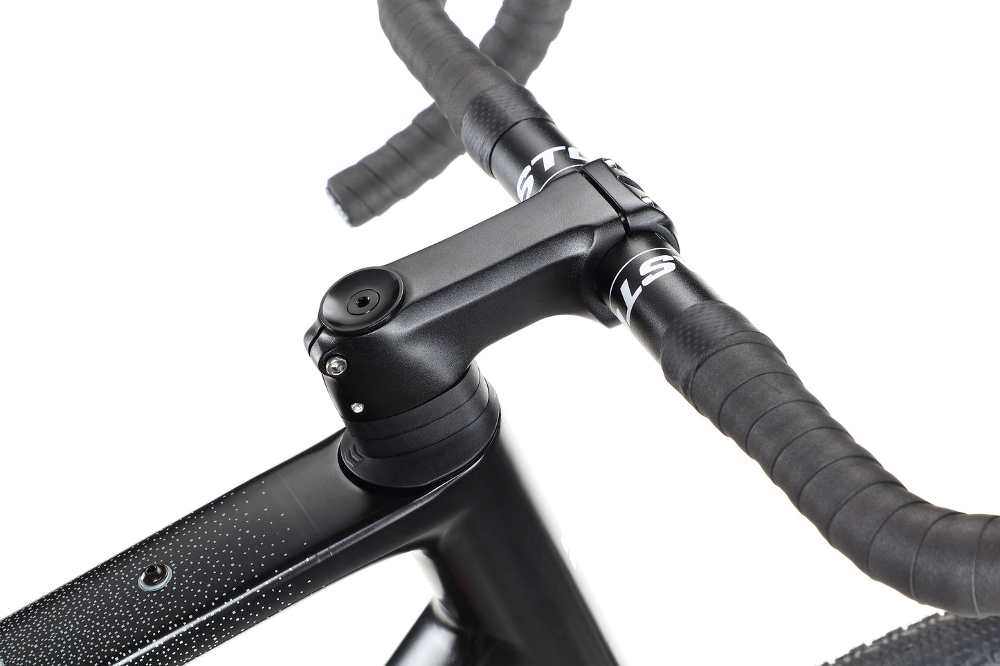 Close-up of the Buzzard Carbon 2 handlebar and stem with internal cable routing, black textured finish, and angle adjustment.