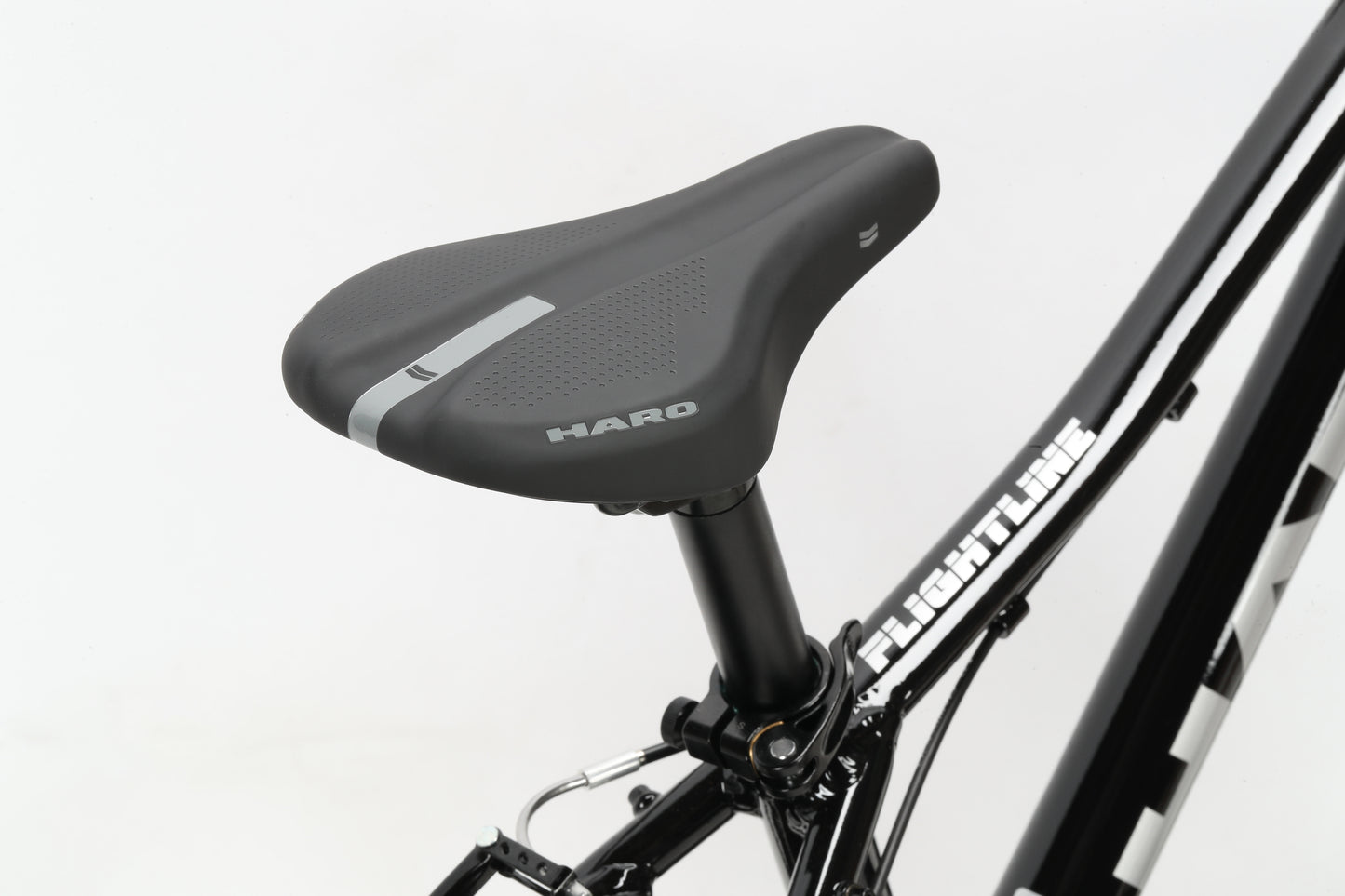 Close-up of a black HARO seat and seat post on a Flightline 20 frame with 20 wheels, against a white background.