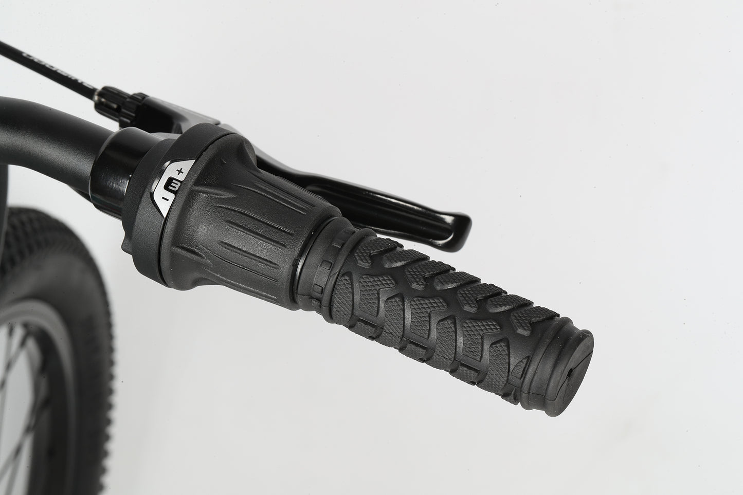 Close-up of Flightline 24s black handlebar with textured grip and 1x7-speed drivetrain, shown on a plain white background.