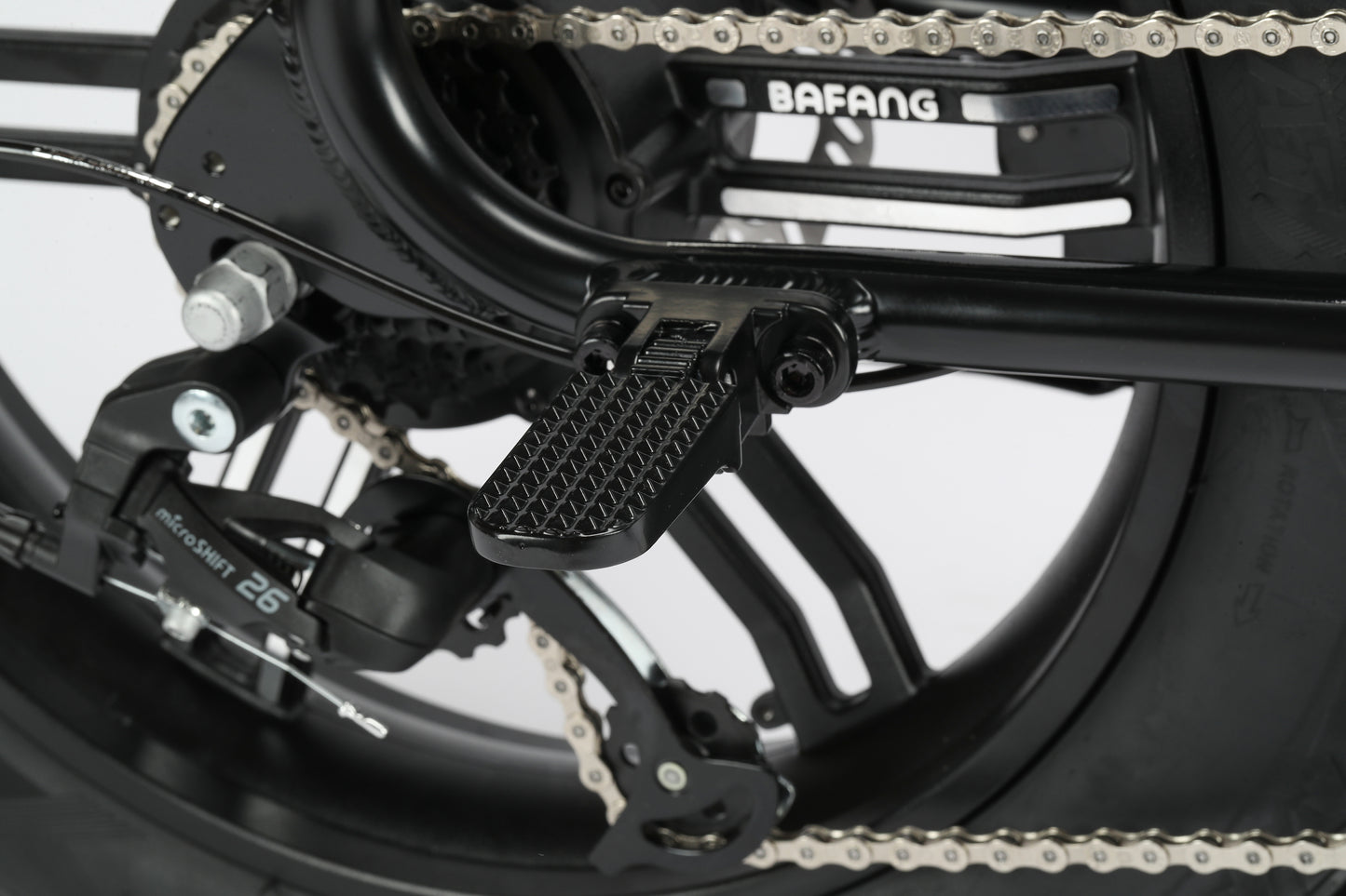 Close-up view of a Haro Bikes Skwad 2 E-bikes rear wheel, showcasing the pedal, chain, frame labeled BAFANG, and Innova IA-2545 tire. Features a robust 500W motor for effortless pedal assist.