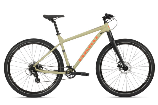The Beasley Two 29 is a beige adventure bike with hydraulic disc brakes, black seat, handlebars, and tires on a white background.