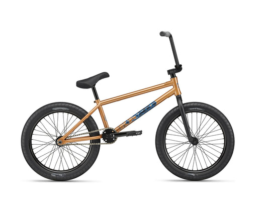 Dana gold BMX bike with black tires, straight handlebars, and Haro geometry for pro street riding; side view on white.