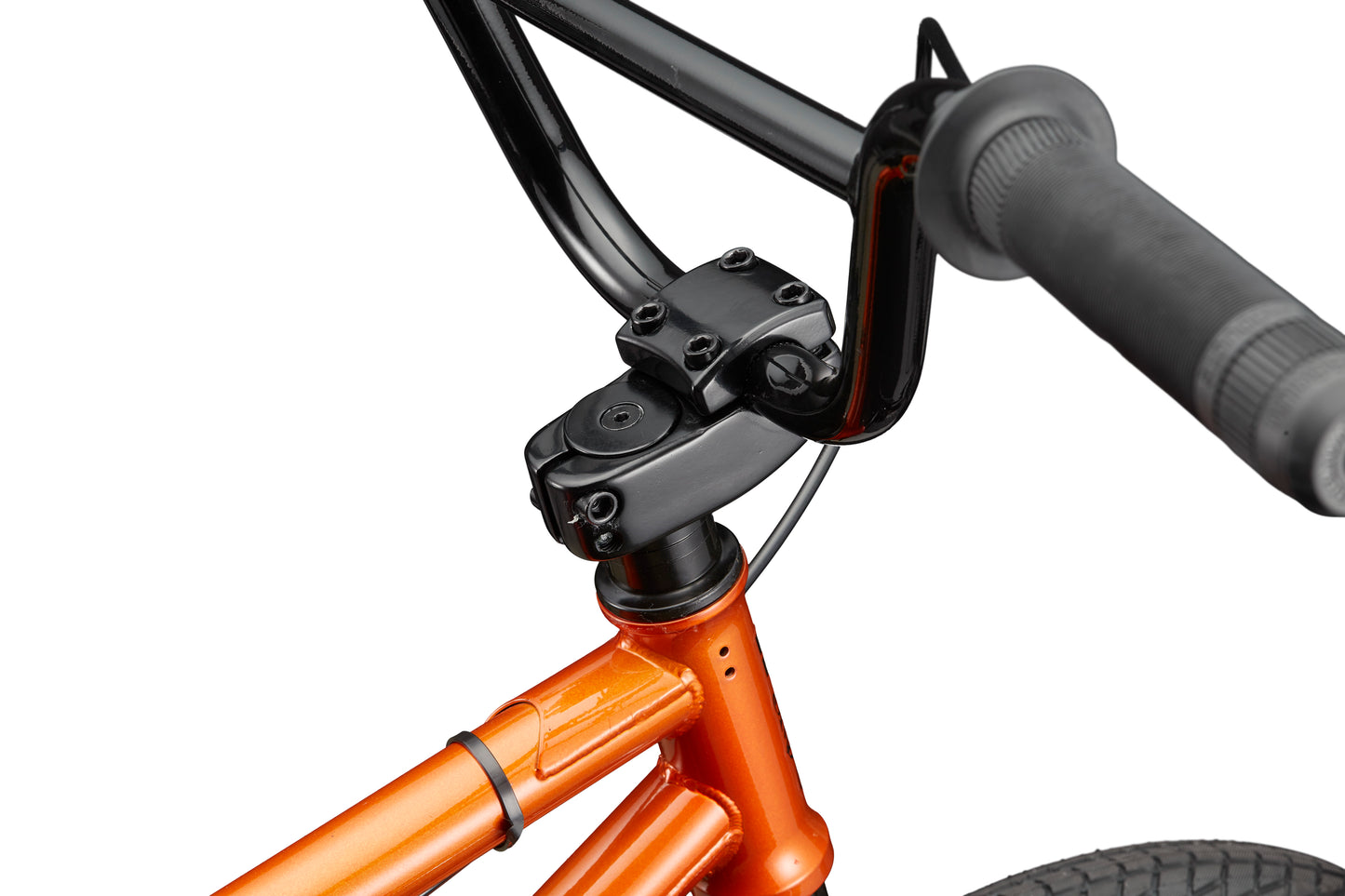 Close-up of a Downtown 18 BMX with black handlebar and stem, orange frame, and front wheel—ideal for small riders.