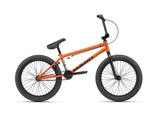 The Haro Downtown 20 entry-level BMX, in bright orange with black tires, seat, and handlebars, shown side view on white background.