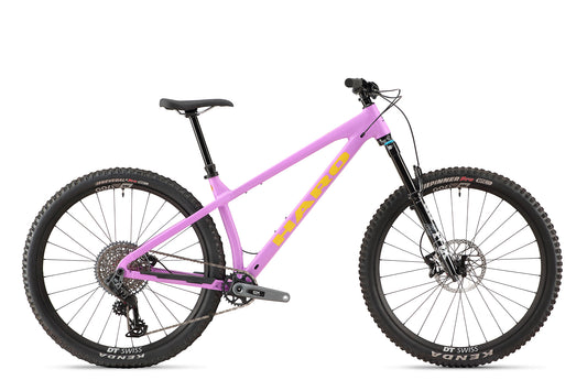 A pink Saguaro 1 bike with thick tires, hydroformed aluminum frame, disc brakes, and black seat shown in side profile.
