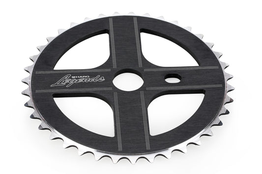 A black Legends Sprocket by Haro Bikes features silver edges, cutout patterns, and Haro Legends text on its surface.