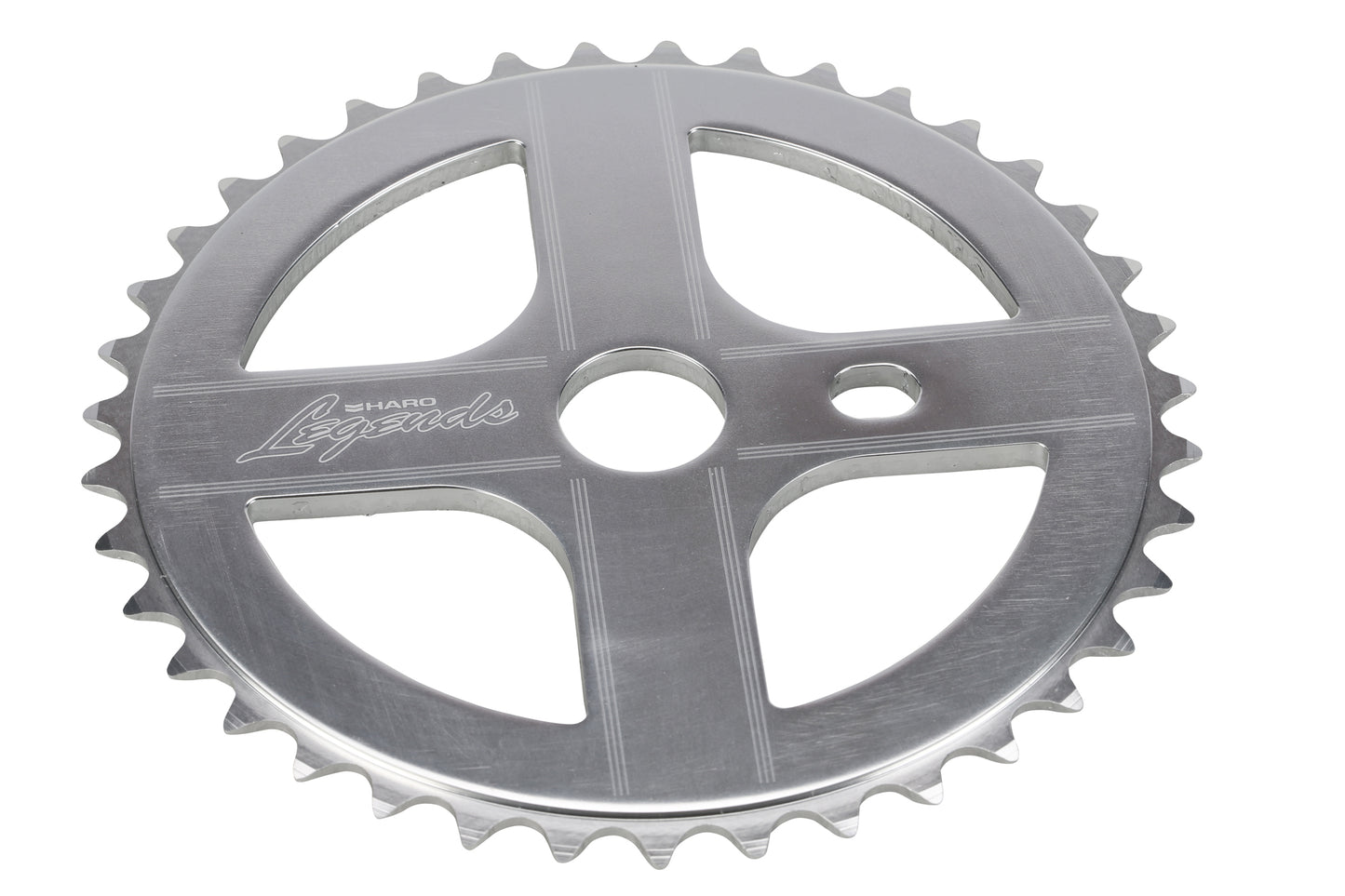 A silver metal chainring branded by Haro Bikes, named Legends Sprockets, with Shadow Legends engraved. It features a central hole and teeth designed to engage with a bike chain.