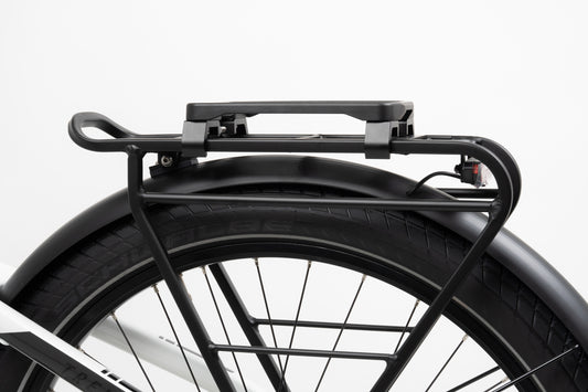 Close-up of a bicycle rear wheel with a black fender and metal rack. Featuring Atran Velos NEWRACK UNI AVS Adapter, it has a simple handle design with visible wheel spokes and part of the white bike frame against a light background. Perfectly compatible with AVS bags for added functionality.