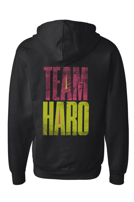 The Haro Bikes Team Haro Hoodie ensures a perfect fit, featuring TEAM HARO in bold, distressed letters for a vintage look. Made from mid-weight fleece, it blends style and comfort with TEAM in pink and HARO in bright yellow.