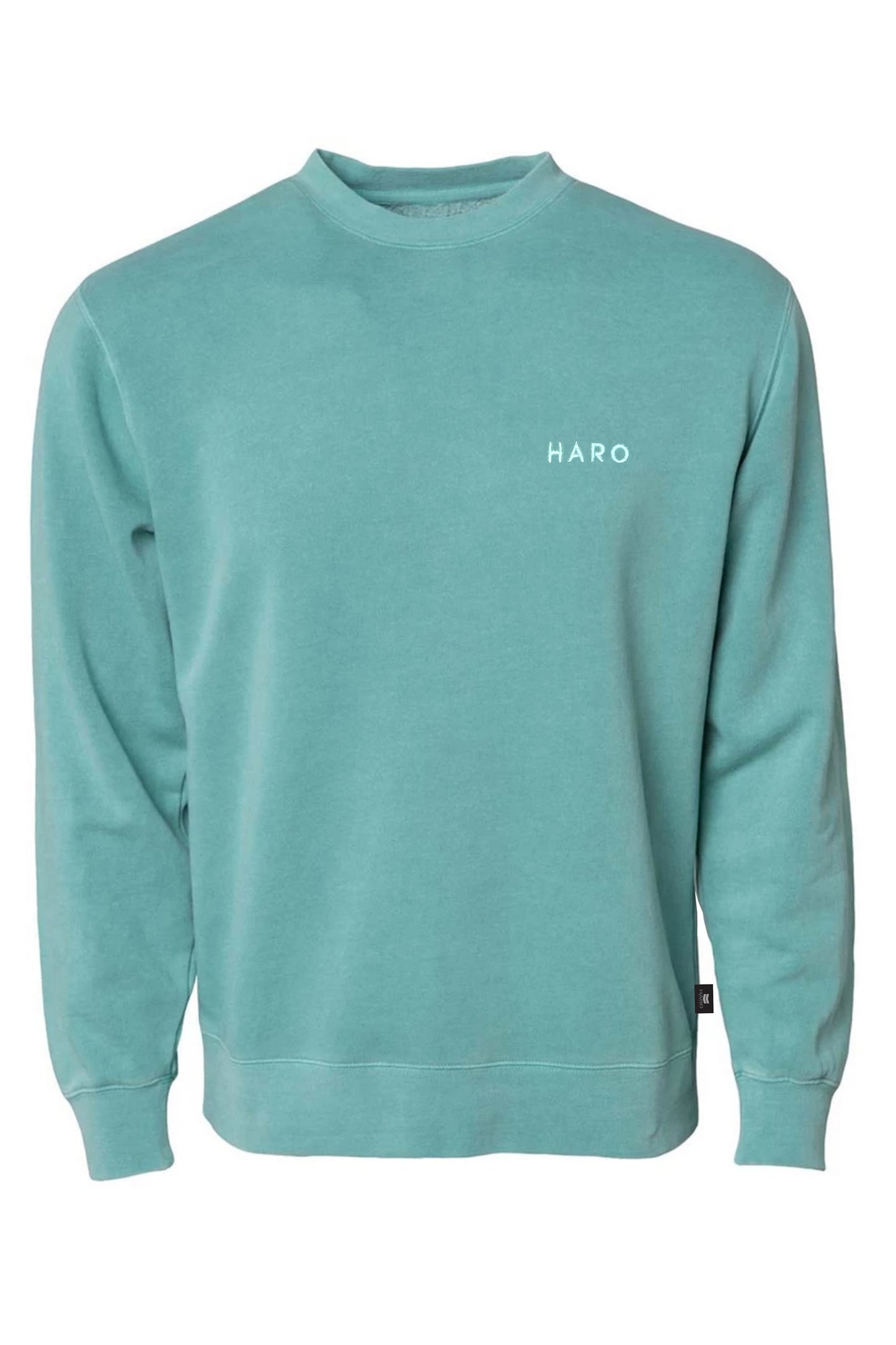 The Haro Thinline Sweatshirt by Haro Bikes is a teal, ultra-soft sweatshirt featuring HARO in small white letters on the left chest. The stylish comfort comes from its long sleeves and crew neckline, made with pigment-dyeing fleece for a unique finish.