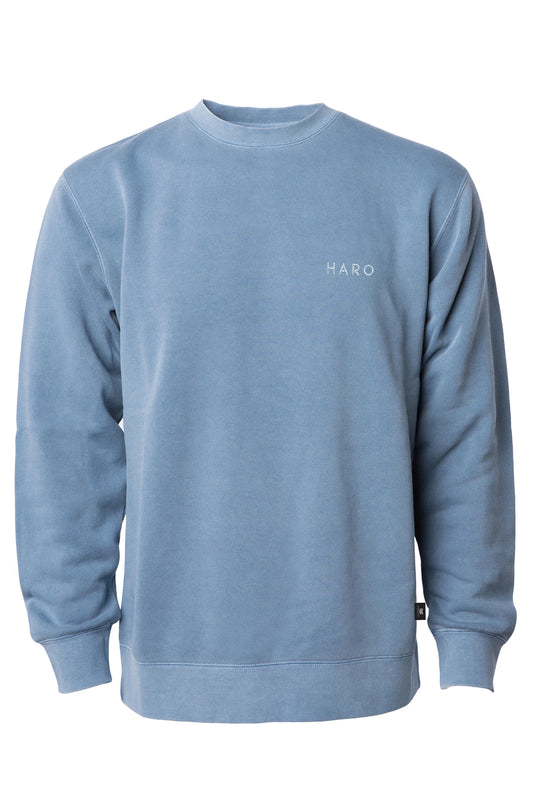 The Haro Thinline Sweatshirt by Haro Bikes is a light blue, ultra-soft crewneck with long sleeves and ribbed cuffs. It boasts HARO in white on the upper left chest and a minimalist design enhanced by pigment-dyed fleece for unique style and comfort.