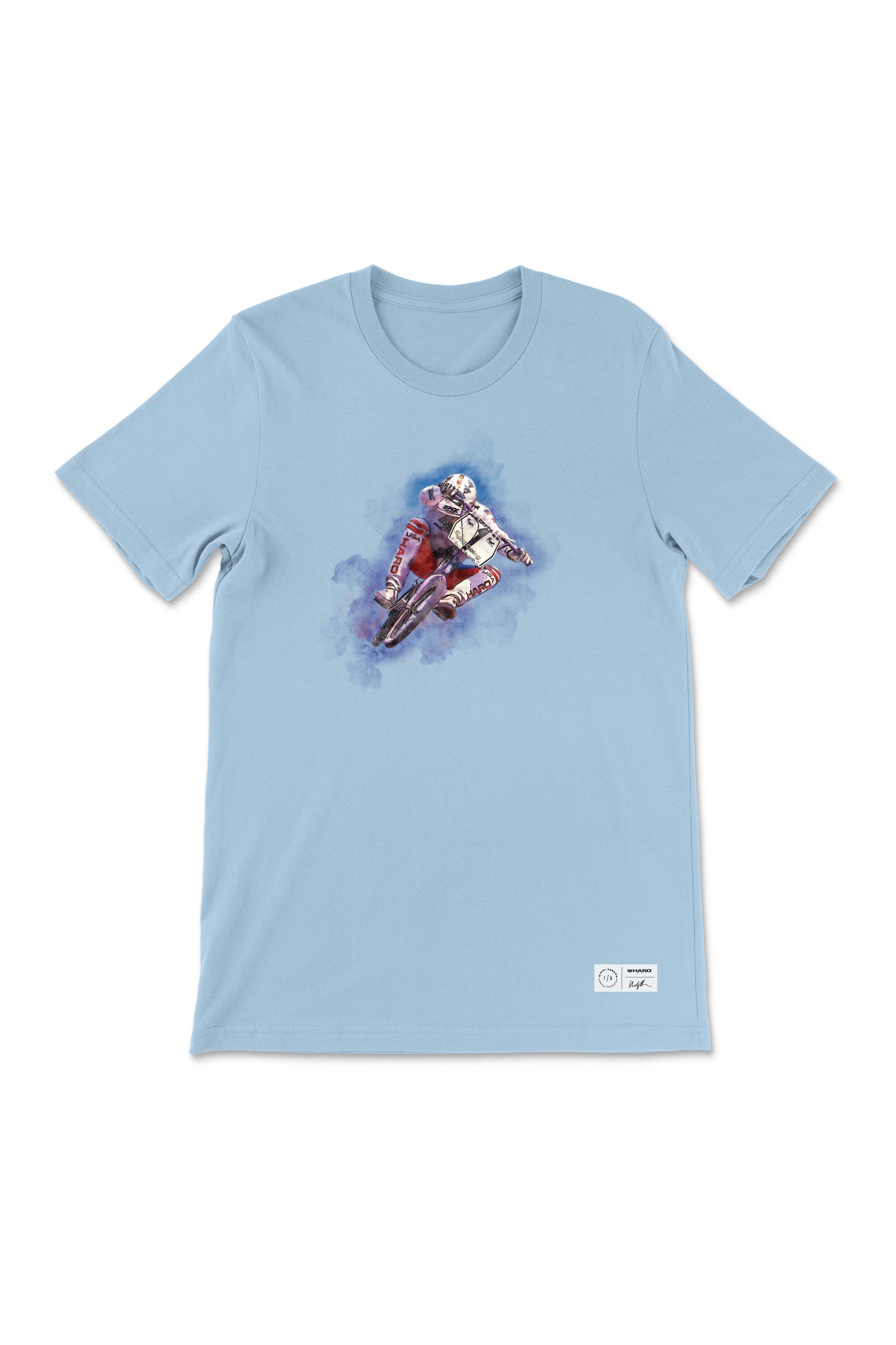 The Windy Osborn Mens Tuck Shirt by Haro Bikes in light blue features a motocross rider with swirling blue smoke. Its crafted from soft, combed ring-spun cotton for ultimate comfort.