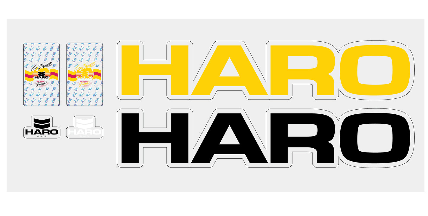 The La Bastille Decal Pack by Haro Bikes includes a sheet of stickers with the brand name in large yellow and black letters, a retro logo with stripes, and two square black-and-white brand text stickers.