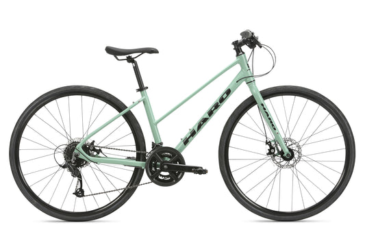 The Aeras ST MicroShift by Haro MTB is a mint green bicycle featuring a lightweight aluminum step-through frame, black handlebars and tires, Microshift gearing, disc brakes, and 700C wheels, perfect for urban commuting or recreational rides.