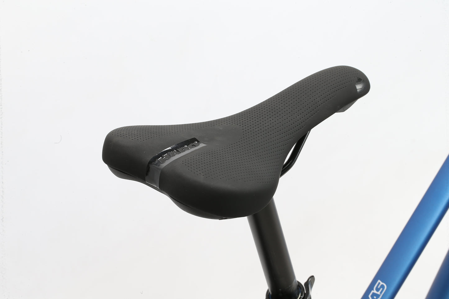 A close-up of the sleek, ergonomic black seat on the Haro MTB Aeras ST MicroShift. Its attached to a vertical seat post with parts of its lightweight aluminum frame visible in blue against a plain white background, accentuating the saddles contours and modern design.