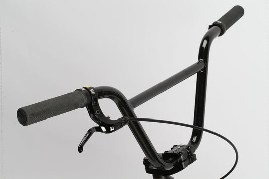 Blackout race-ready black bicycle handlebars with grips and brake lever, on a white background.