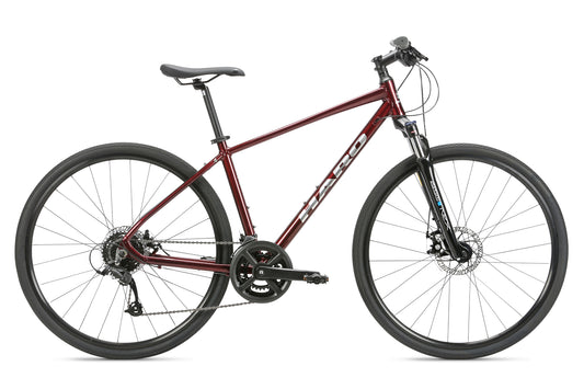 The Bridgeport MicroShift by Haro MTB is a sleek red bicycle with a lightweight frame, flat handlebars, and disc brakes. Positioned against a white background, it boasts thin tires for road cycling and has a comfortable, adjustable seat.