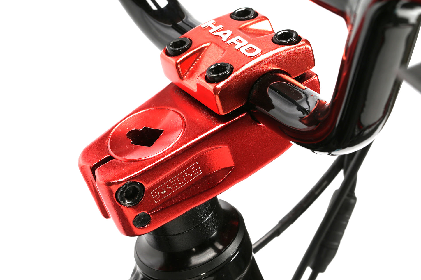 Close-up of a red BMX bike handlebar stem with Haro Bikes and Johnny 5 branding. The black cables and handlebars contrast with the bright metallic red, echoing its BMX-inspired design.