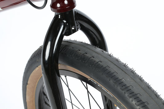 Close-up of a black Quist front fork and tan sidewall tire, inspired by the legendary freestyle machine.