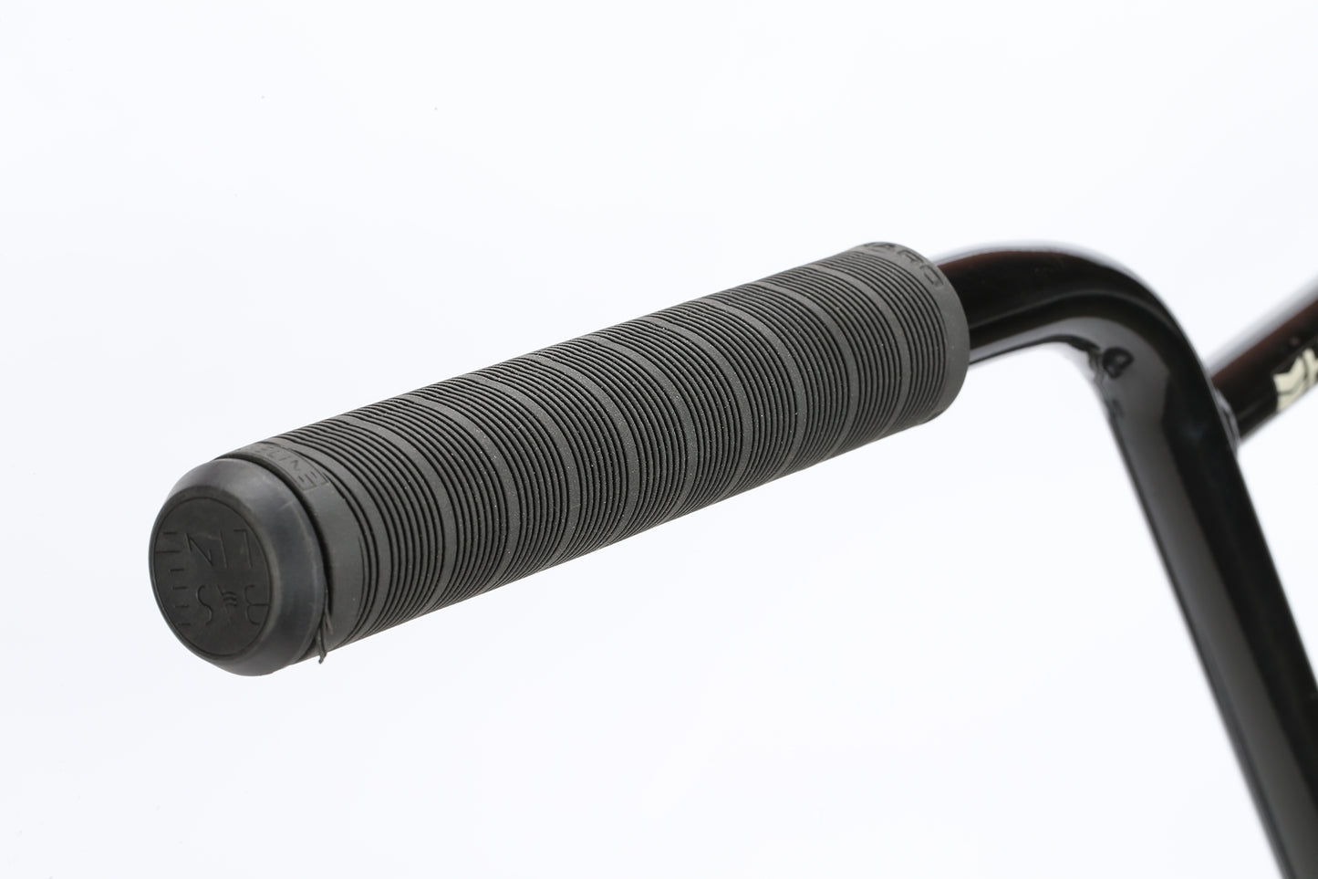 Close-up of a Haro Bikes SD AM handlebar with a textured black rubber grip, set against a plain white background.