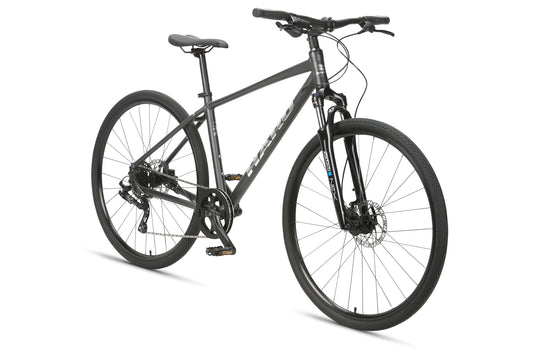 The Haro MTB Westlake MicroShift is a black hybrid bicycle with a lightweight frame, flat handlebars, and disc brakes, featuring thin tires for road and light off-road use. Positioned diagonally against a white background.