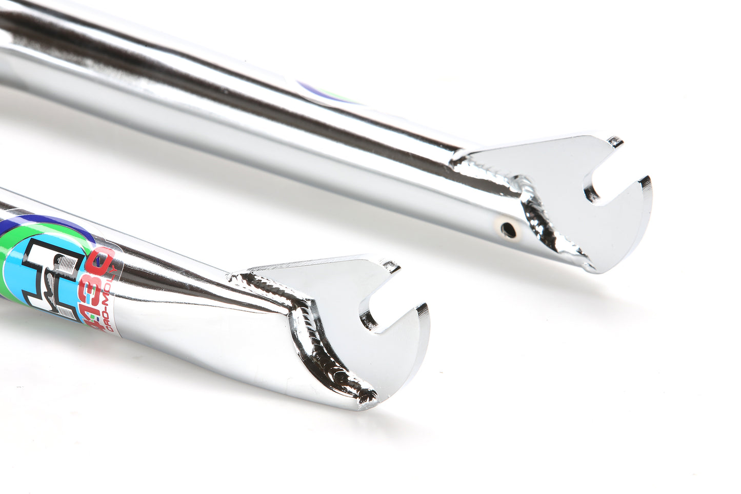 Close-up of Lineage Freestyler Frameset chrome BMX dropouts with colorful decals, inspired by classic Haro Freestyler style.