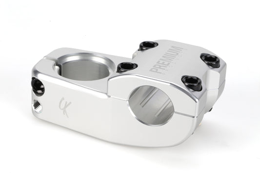 The CK Top Load Stem V3 by Premium is a silver metal stem with multiple screw holes, circular cutouts for attachment, and a bar bore feature on top. Its knee-friendly design boasts a sleek, shiny finish.