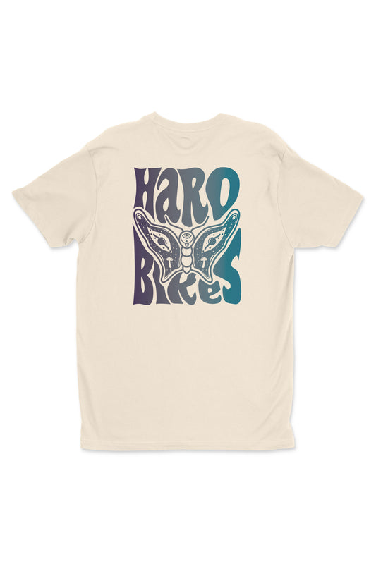 The Butterfly Shirt by Haro Bikes is a beige T-shirt featuring an intricate butterfly graphic with Haro Bikes in bold, stylized vertical letters on the back.