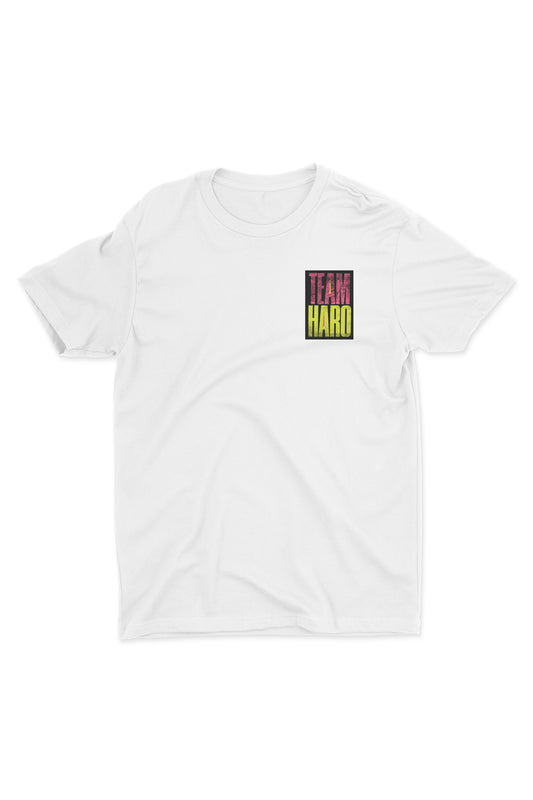 The Team Haro Shirt by Haro Bikes is a plain white tee with a small multicolored TEAM HARD logo on the upper left chest, ideal for layering under a hoodie.