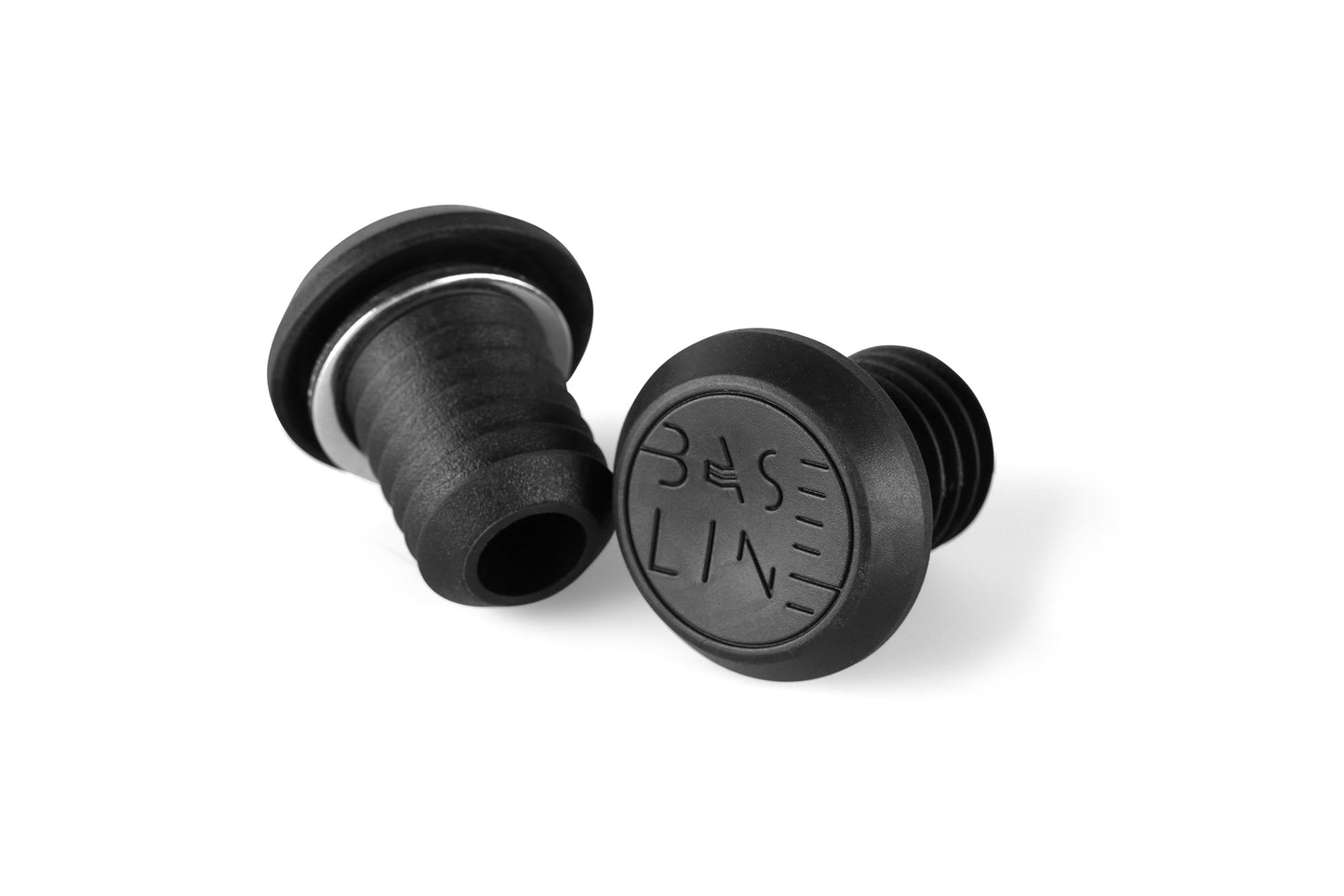 Two black rubber stoppers, one upright and the other on its side, resemble Baseline Bar Ends by Haro Bikes. Both have textured grips and BASELINE embossed on top.