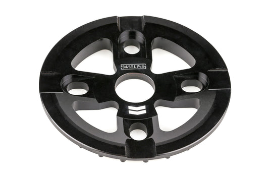 The Baseline Guard Sprocket by Haro Bikes is a sleek black component made from 6061 CNC Aluminum. It features multiple spokes with openings, an engraved brand logo on one spoke, along with a glossy finish and a central hole for enhanced functionality.