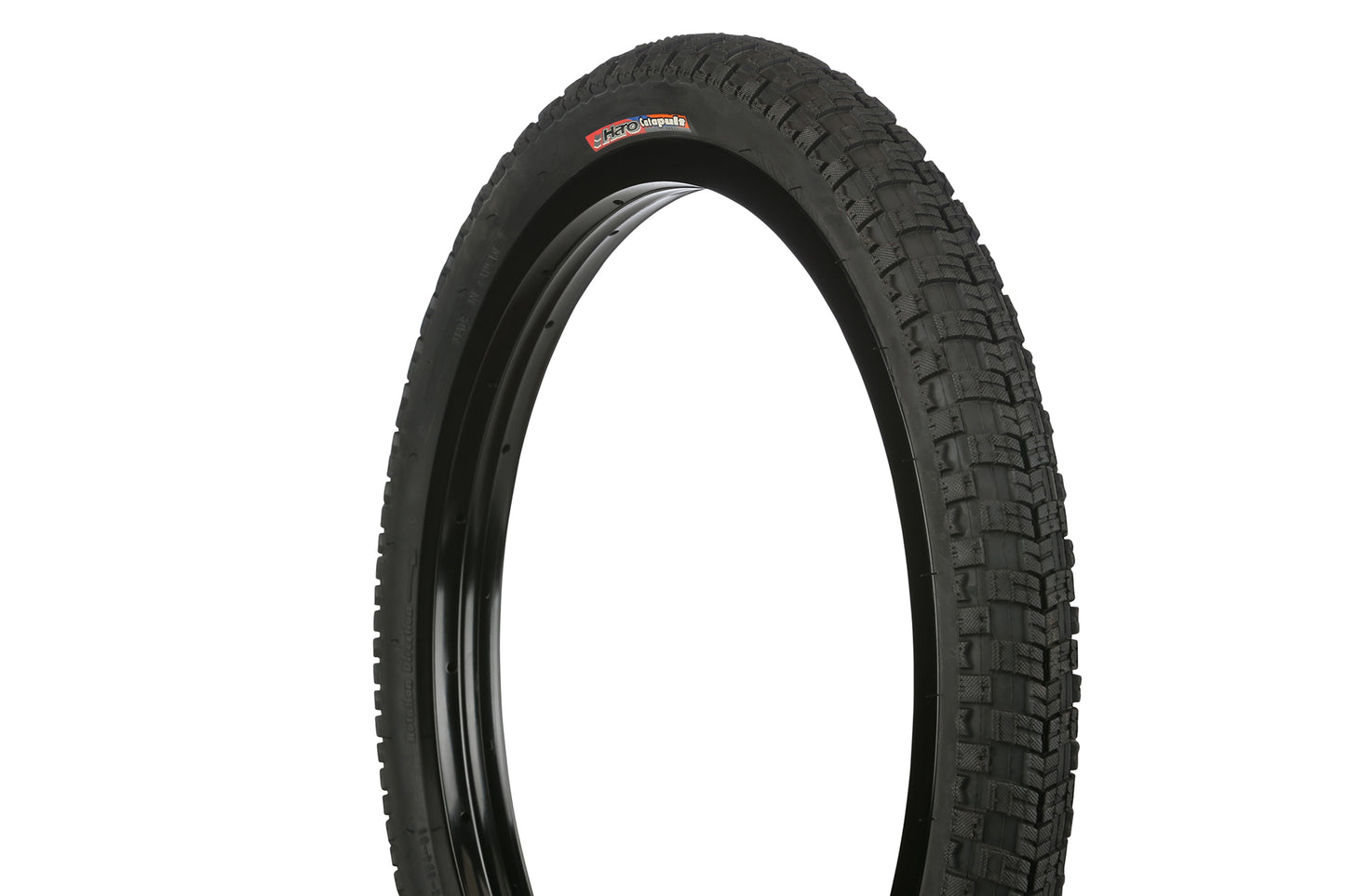 The Haro Bikes Catapult Tire, standing upright against a white background, showcases its detailed tread pattern on the sidewall with the brand name visible. Ideal for those seeking to sell tires known for their reliable performance and available in multiple sizes.