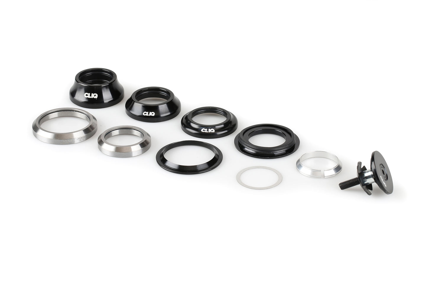 The Cliq Integrated Tapered Headset by Haro Bikes features precision machined aluminum components on a white background, including black and silver rings, curved parts, washers, and a bolt with a black top cap.