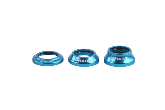 Three blue metallic spacers of varying sizes are aligned in a row, embodying a Campy style. Each cylindrical, slightly tapered spacer proudly displays Haro Bikes on its side. Their sleek design is highlighted against the plain white background.