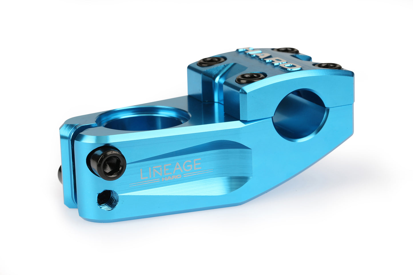 Close-up of a polished blue BMX Haro Bikes Lineage Top Load Stem, made from 6061 aluminum. It features LINEAGE HARD engraved on the side and is secured with six black bolts, all against a white background.