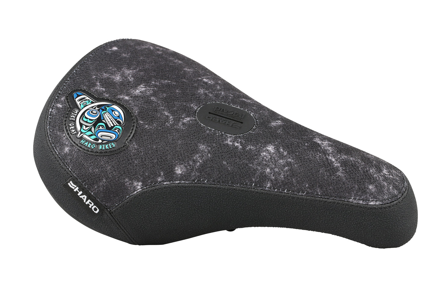 The Mike Gray Pivotal Seat by Haro Bikes features a black design with a white speckled pattern, a tribal motif on the top left, Haro on the side, and a textured surface.