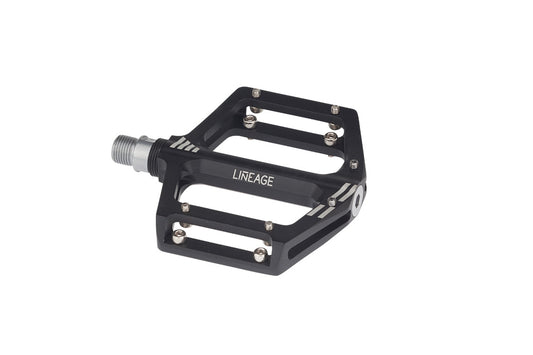 Haro Bikes Lineage Pedals are black, lightweight 6061 aluminum bicycle pedals with a flat rectangular shape, featuring LINEAGE printed on them and replaceable silver pins for grip. They attach via a threaded spindle.