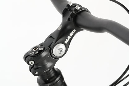 Close-up of a black bicycle handlebar with the Haro MTB logo. It features a pivot adjustment, attached to the PD4 27.5 frame. The image highlights the stem and handlebar connection on a white background.