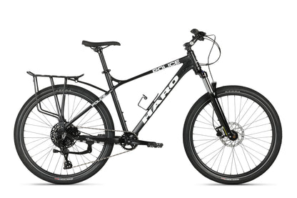 A Haro MTB PD4 27.5 black mountain bike with Police branding, boost spacing, rear cargo rack, front suspension fork, and disc brakes features a robust rear wheel design as it stands against a plain white background.