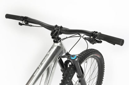 Close-up of the limited edition Haro MTB Daley Alloy LTD 2 mountain bikes front section, showcasing the handlebars and Fox suspension fork. The silver frame gleams with black handles and tires against a plain white background.