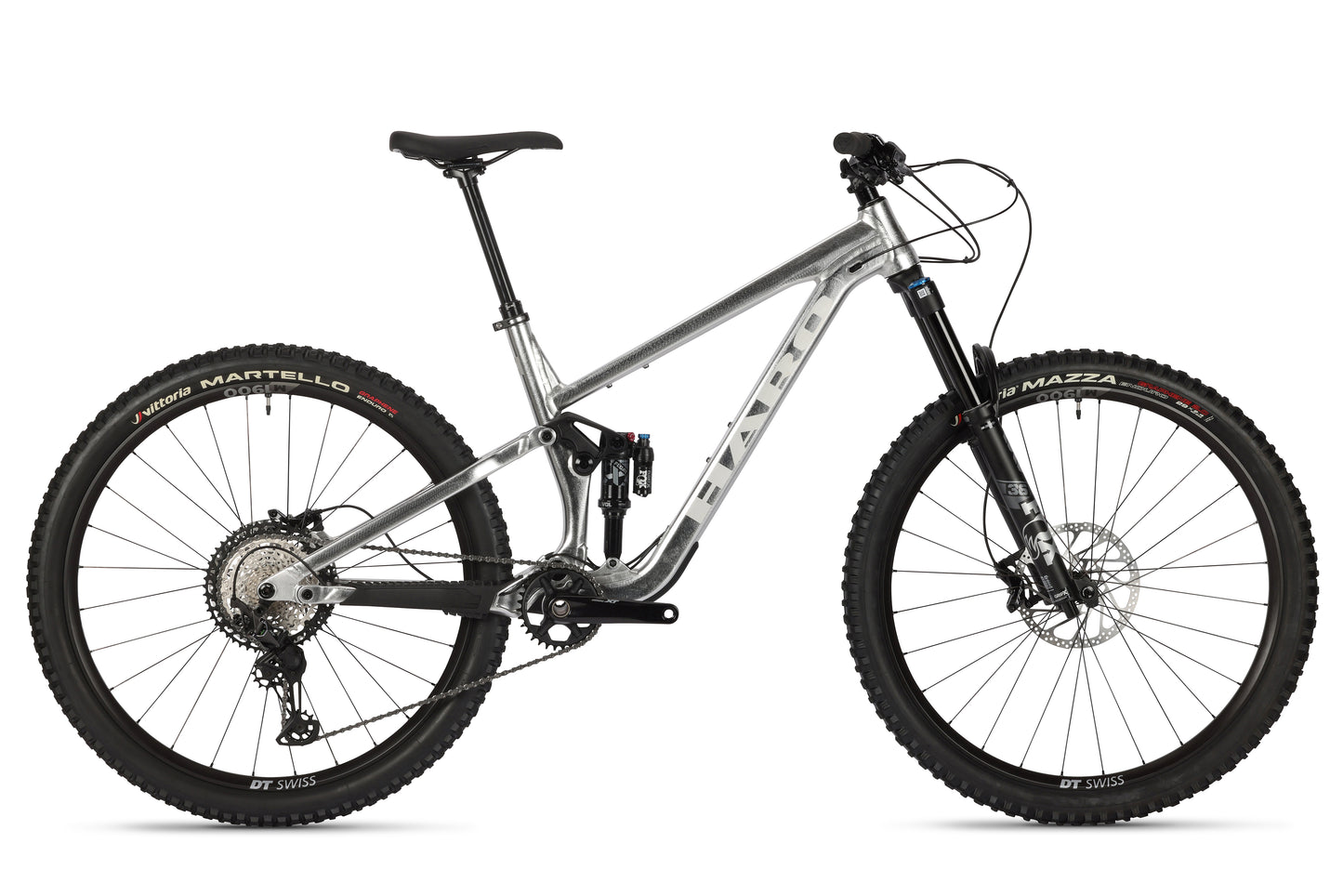 The Haro MTB Daley Alloy LTD 2 is a silver mountain bike with a sturdy frame, disc brakes, and rugged tires. It features limited edition Fox suspension for off-road terrains and wheels showcasing brand logos in red lettering.