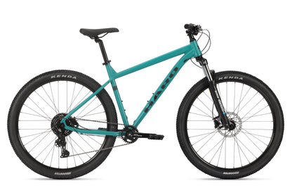 The Flightline LTD 29 by Haro MTB features Shimano Cues, large black tires for any terrain, and Tektro hydraulic brakes. Its sturdy teal frame, straight handlebar, and black seat complete this bike ideal for thrilling outdoor cycling adventures.