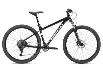 A black Haro MTB Flightline 1 29 hardtail mountain bike features a sturdy frame, knobby tires, and front suspension fork. It has Shimano 8-speed Essa gearing, hydraulic disc brakes, and flat handlebars with the brand name on the frames side.