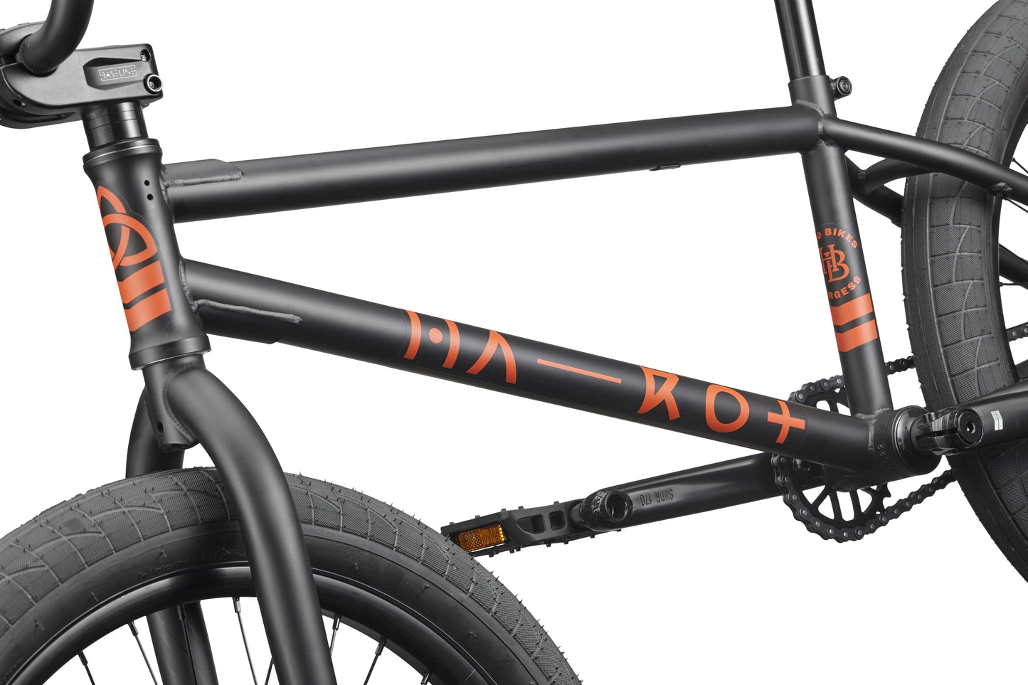 Close-up of the Burgess black BMX frame with orange graphics, designed for advanced riding and thick front and rear tires.