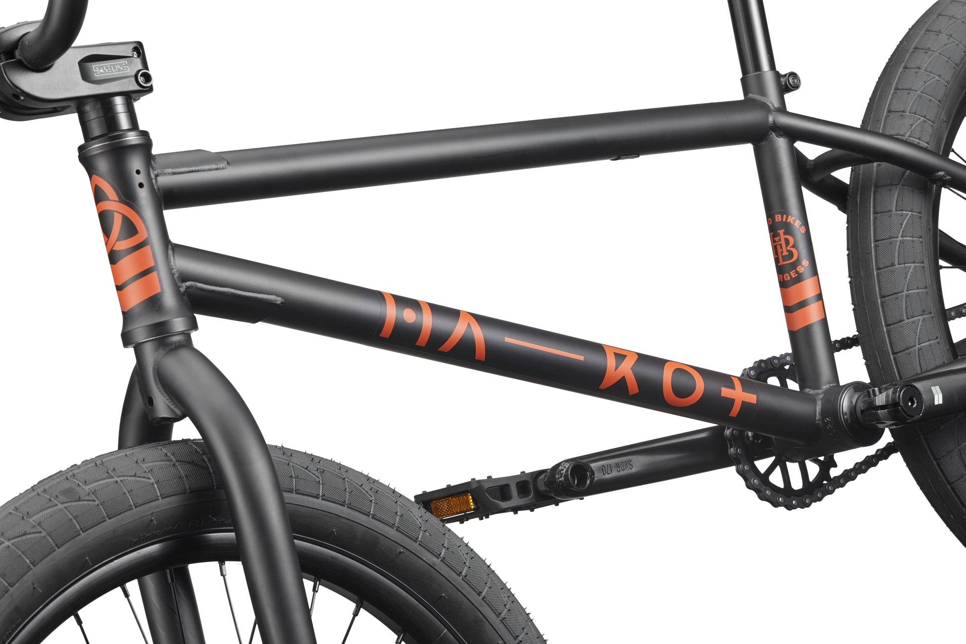 Close-up of the Burgess black BMX frame with orange graphics, designed for advanced riding and thick front and rear tires.