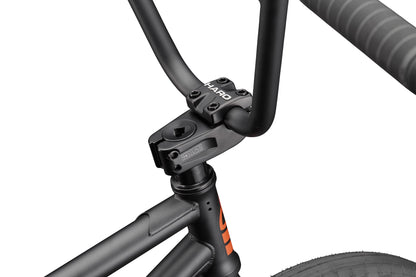 Close-up of the Burgess BMX’s handlebars, stem, and frame—an agile bike built for high-level riding against a white background.