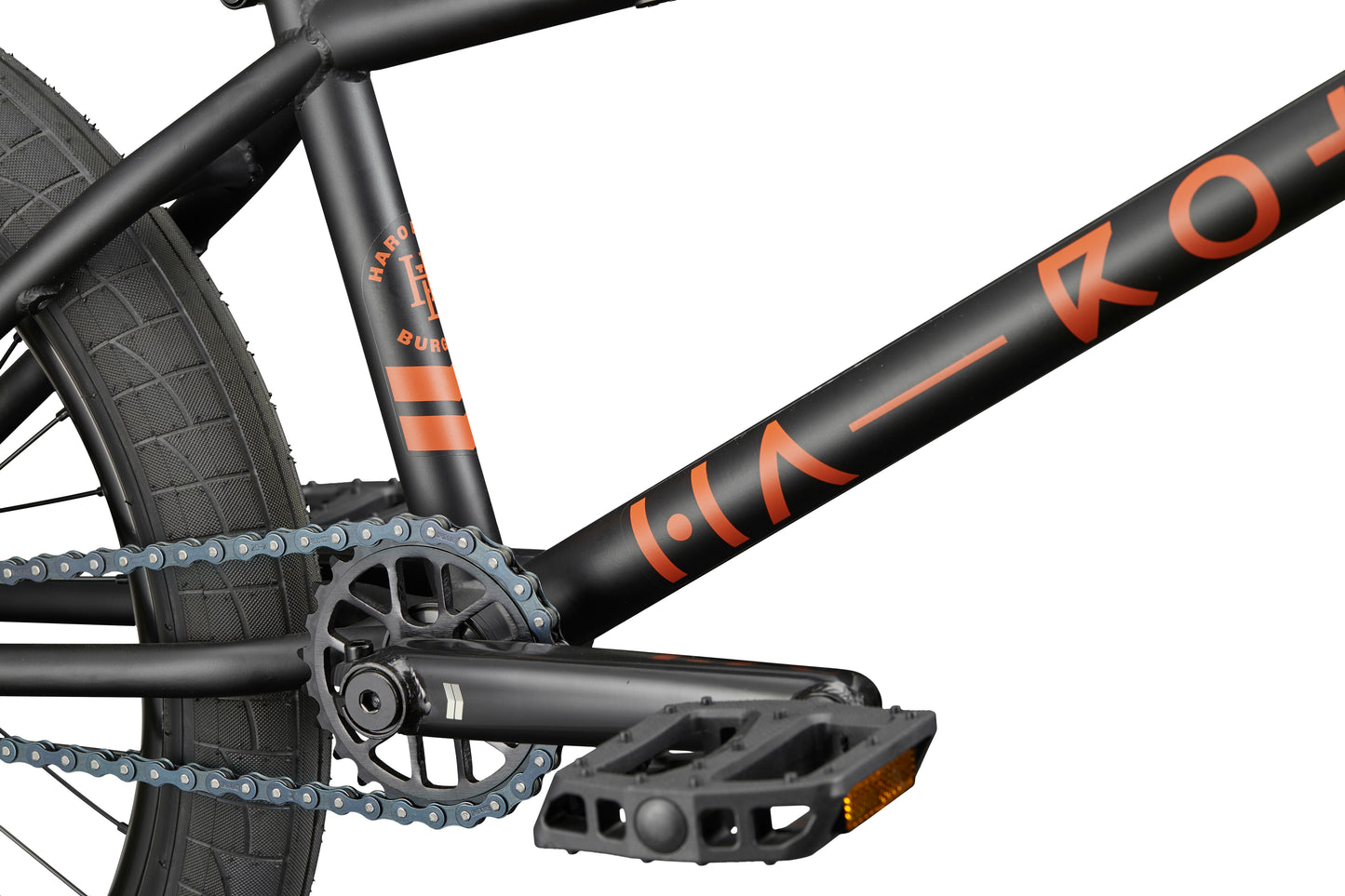 Close-up of the Burgess bike frame, showcasing the pedal, chain, crank, and rear wheel against a white background.