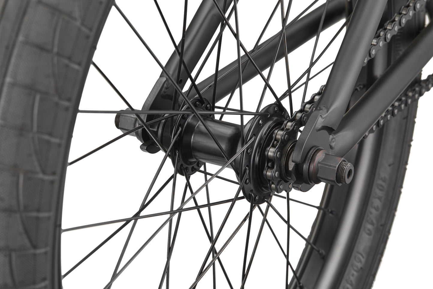 Close-up of the Burgess bike’s rear wheel, highlighting spokes, hub, axle, and chain—ideal for advanced riding.