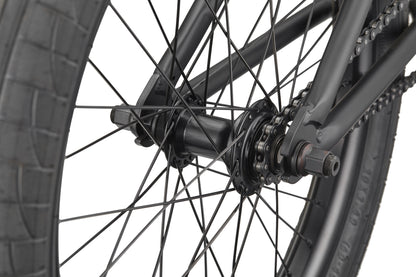 Close-up of the Burgess bike’s rear wheel, highlighting spokes, hub, axle, and chain—ideal for advanced riding.
