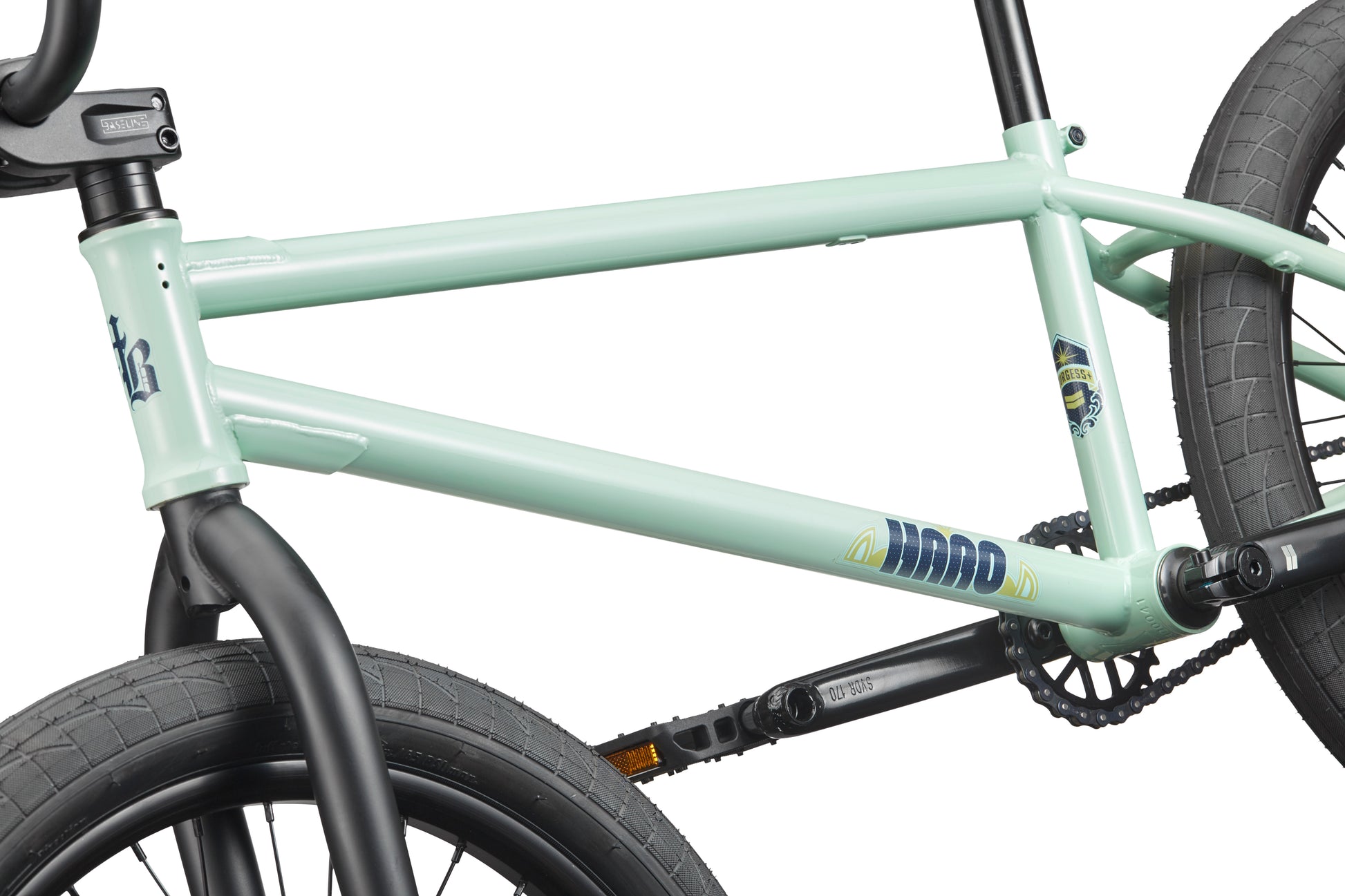 Close-up of the Burgess, a versatile light green BMX bike with black handlebars, wheels, and crankset.